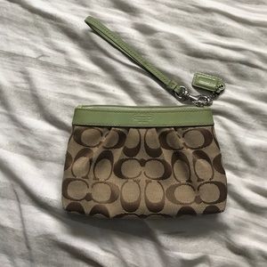 Coach wristlet. Shows wear as reflected in price.